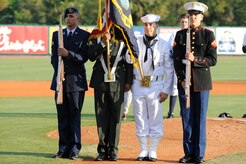 The Naval Brig Charleston color guard Team presents the colors during the National Anthem prior to the Charleston RiverDogs baseball game at Joseph P. Riley Jr., Park May 13,2010.