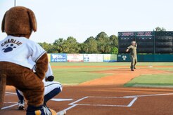 Col. Mike Speer winds up for the first pitch at the start of the Charleston RiverDogs baseball game at Joseph P. Riley Jr., Park May 13, 2010. Colonel Speer is retiring after a 26-year career with the Air Force, serving both as active duty and Reserve. The Charleston RiverDogs held a military appreciation night, which was free to all military and Department of Defense ID cardholders and their families. The Charleston RiverDogs beat the Augusta GreenJackets, 3-2. Colonel Speer is vice commander of the 315th Airlift Wing. See more pictures on Page 22.