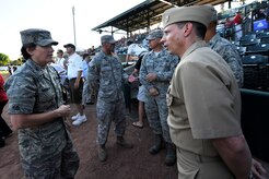 U.S. Air Force Col. Martha Meeker speaks with Navy Command Master Chief Petty Officer Bill Cady during the Charleston RiverDogs baseball game at Joseph P. Riley Jr., Park May 13, 2010. Colonel Meeker is the commander of Joint Base Charleston and Master Chief Cady is the Command Master Chief for Naval Weapons Station Charleston.