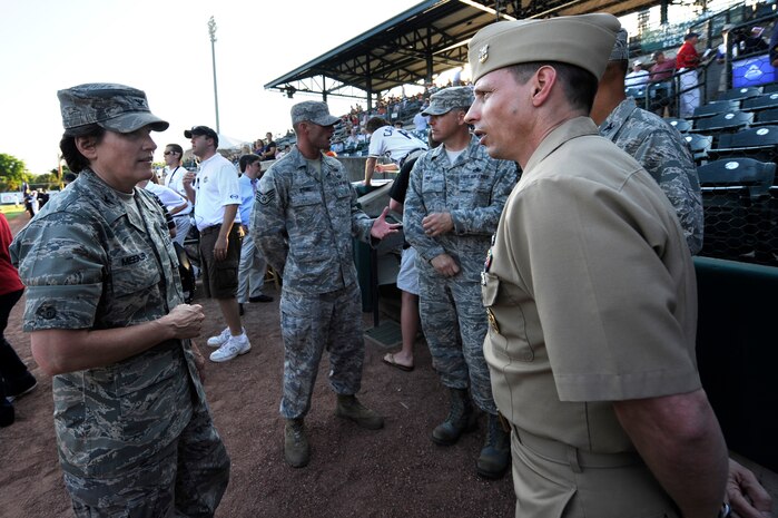 U.S. Air Force Col. Martha Meeker speaks with Navy Command Master Chief Petty Officer Bill Cady during the Charleston RiverDogs baseball game at Joseph P. Riley Jr., Park May 13, 2010. Colonel Meeker is the commander of Joint Base Charleston and Master Chief Cady is the Command Master Chief for Naval Weapons Station Charleston.