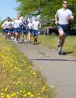 Staff Sgt Thomas Mihalyi leads the pack of 50th Intelligence Squadron members in a 5K run at Beale Air Force Base, Calif., May 2.  The fundraising event was held in support of Gunnery Sergeant Carraway of the Marine Corps Systems Command at the Pentagon who recently underwent surgery for a brain tumor. Approximately twenty 940th Wing Reservists and 13th Intelligence Squadron active duty members, ran the course to raise money for cancer research at Camp Pendleton, Calif. (U.S. Air Force Photo/Tech. Sgt. Luke Johnson)