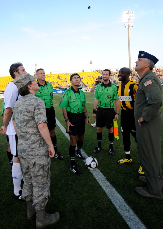 Col. Martha Meeker, left, and Col. Mike Speer, right, call a coin in the air during the opening ceremony for Military Appreciation Night at the Charleston Battery game May 15, 2010 at Blackbaud Stadium on Daniel Island. Both commanders served as honorary team captains during the military appreciation game. Colonel Meeker is the commander of Joint Base Charleston and Colonel Speer is the vice commander of the 315th Airlift Wing at Joint Base Charleston. (U.S. Air Force photo/Senior Airman Timothy Taylor)
