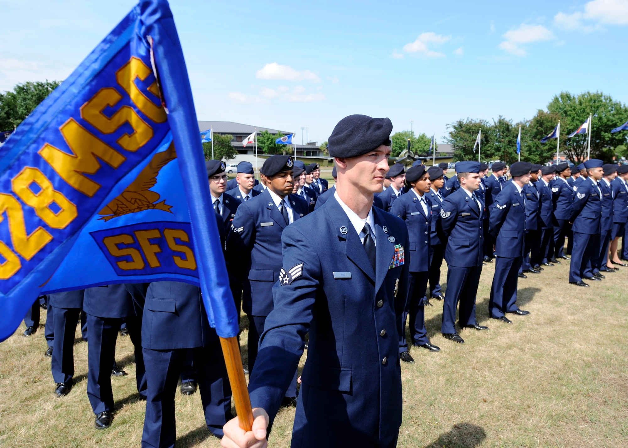 Staff Sgt. Michael Whitcomb stands at ease as he holds the 628th Security Forces Squadron guidon during the "National Police Week" retreat ceremony May 14, 2010 at the base flag pole on Joint Base Charleston, S.C. In 1962, President John F. Kennedy signed a proclamation which designated May 15th as Peace Officers Memorial Day and the week in which the date falls as Police Week. Sergeant Whitcomb is a security forces trainer with the 628 SFS. (U.S. Air Force photo/Senior Airman Timothy Taylor)