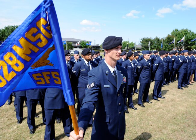 Staff Sgt. Michael Whitcomb stands at ease as he holds the 628th Security Forces Squadron guidon during the "National Police Week" retreat ceremony May 14, 2010 at the base flag pole on Joint Base Charleston, S.C. In 1962, President John F. Kennedy signed a proclamation which designated May 15th as Peace Officers Memorial Day and the week in which the date falls as Police Week. Sergeant Whitcomb is a security forces trainer with the 628 SFS. (U.S. Air Force photo/Senior Airman Timothy Taylor)