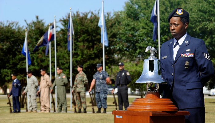 Staff Sgt. Veronica Odom stands ready to chime the ceremonious bell to honor police officers who have been killed in the line of duty May 14, 2010 at the base flag pole on Joint Base Charleston, S.C. Joint Base Charleston held numerous activities and events for "National Police Week," to include friendly competition between 628th Security Forces Sqaudron and 628th Civil Engineer Squadron, Scruff McGruff "The Crime Dog" visited the Child Development Center and a chili cook off. Sergeant Odom is a security forces trainer with the 628 SFS. (U.S. Air Force photo/Senior Airman Timothy Taylor)