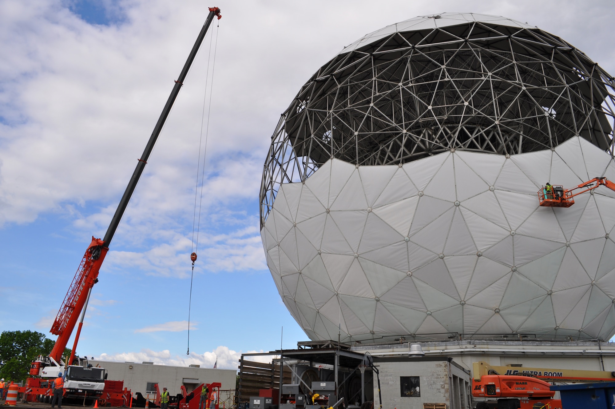 Workers remove some of the skin from the Haystack Radar in Tyngsborough, Mass. May 14.  Electronic Systems Center is working with MIT Lincoln Laboratory and Air Force Space Command on a major upgrade of the system that involves replacing the existing radar.  (U.S. Air Force photo by Harsheet Shah)