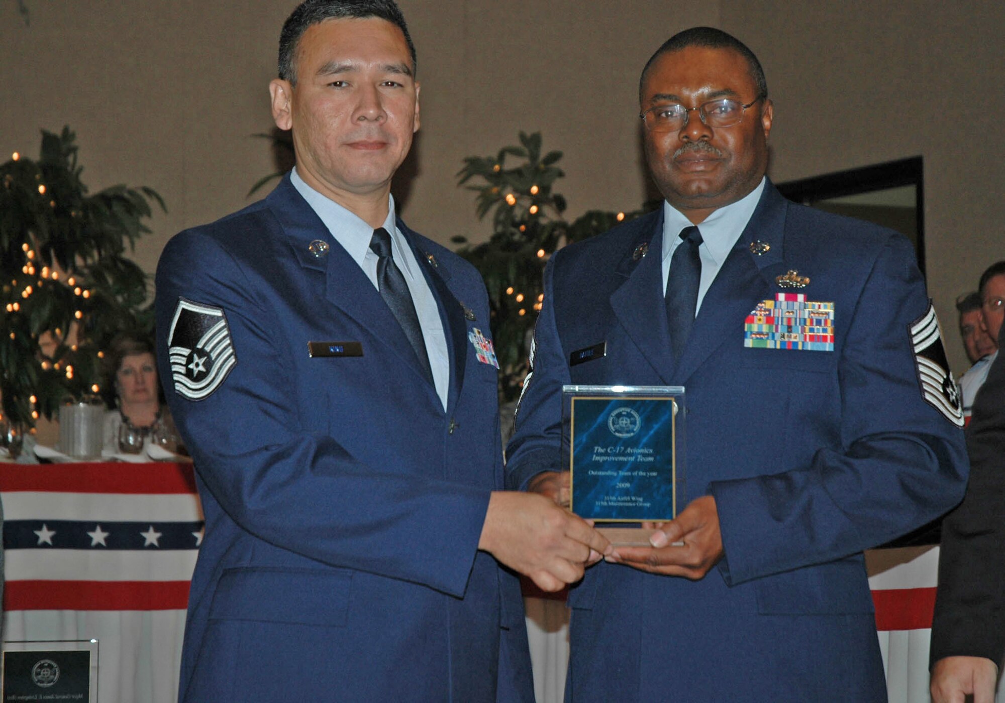 Chief Master Sergeant Battle and Master Sergeant Buddy King accept the 2010 Federal Employee of the Year Award for the C-17 Avionics Team 315th Airlift Wing Charleston Air Force Base, S.C.