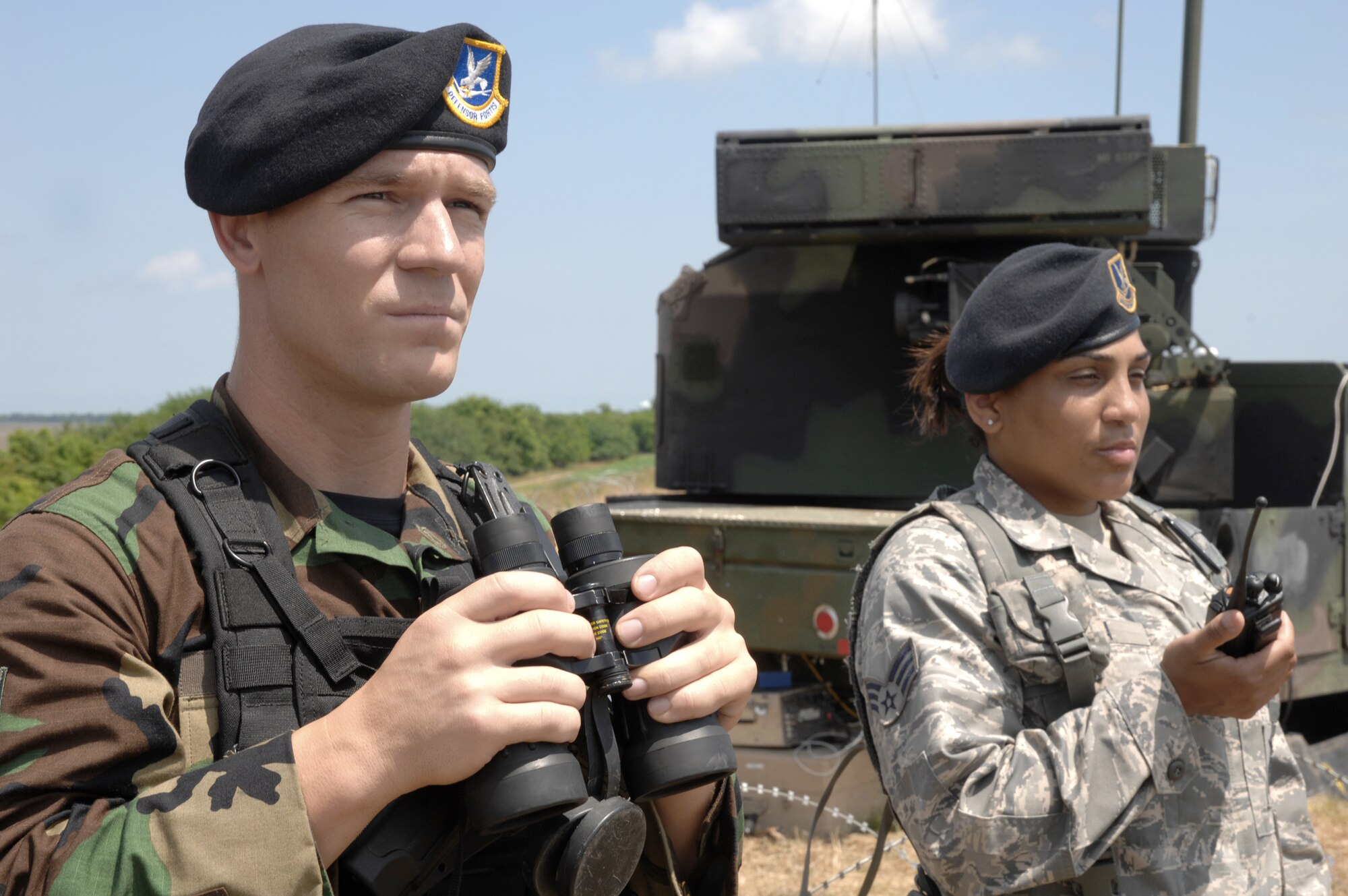 Staff Sgt. Josh Hartzell and Senior Airman Vanessa Garcia provide perimeter security for the Avenger air defense missile system during Exercise Ardent Sentry '10 May 15, 2010, in Savannah, Ga. Sergeant Hartzel l and Airman Garcia are from the 165th Security Forces Squadron. (U.S. Air Force photo/Tech. Sgt. Anika Williams)