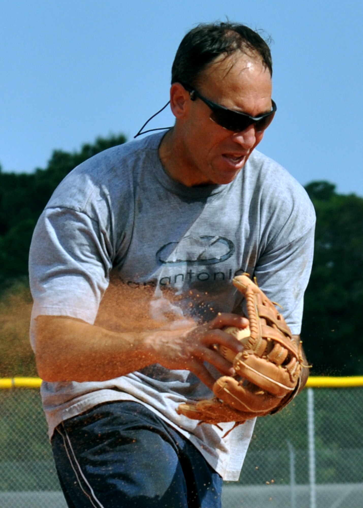 Col. Charles Greenwald, Air Armament Center vice commander, gathers up the ball at third base during the annual Chiefs V/S Eagles softball match at Eglin Air Force Base, Fla., May 17.  The Eagles narrowly won 9-8 in extra innings.  (U.S. Air Force photo/Samuel King Jr.)
