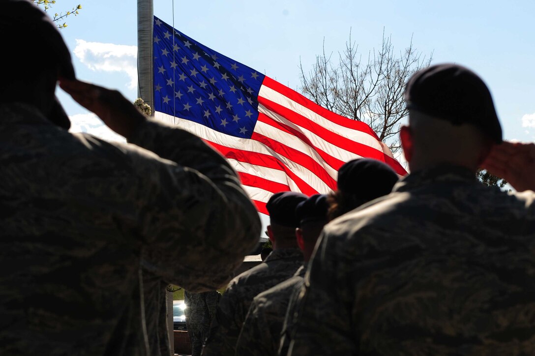 ELLSWORTH AIR FORCE BASE, S.D. -- Members of the 28th Security Forces Squadron salute the flag during a National Police Week Retreat ceremony, May 14.  Events throughout the week, such as a National Police Week 5k run, were held in honor of police officers both past and present. (U.S. Air Force photo/Airman 1st Class Corey Hook)