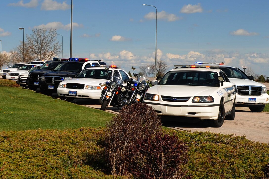 ELLSWORTH AIR FORCE BASE, S.D. -- South Dakota and 28th Security Forces Squadron law enforcement vehicles line up with their lights on at the National Police Week Retreat ceremony, May 14.  Peace Officers Memorial Day, a holiday created by former United States President John F. Kennedy, is recognized on May 15 every year. (U.S. Air Force photo/Airman 1st Class Corey Hook)