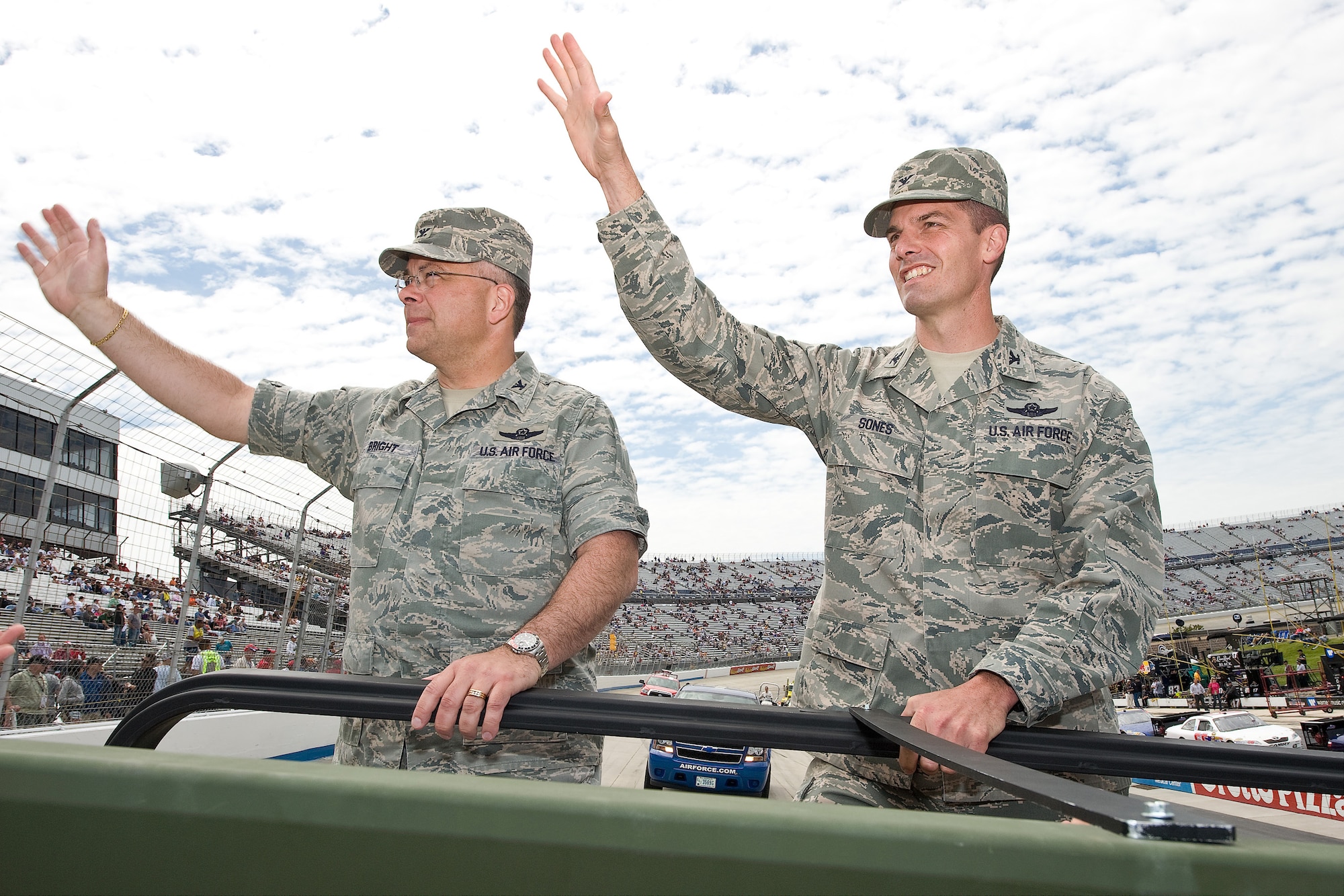 (Left) Col. Randal Bright, 512th Airlift Wing commander, and Col. Dwight Sones, 436th Airlift Wing vice commander, wave to the crowd during the opening ceremony of the NASCAR Nationwide Series race May 16. It is a Dover tradition for the leaders of Dover Air Force Base to ride in the pre-race parade. (U.S. Air Force photo/Roland Balik)