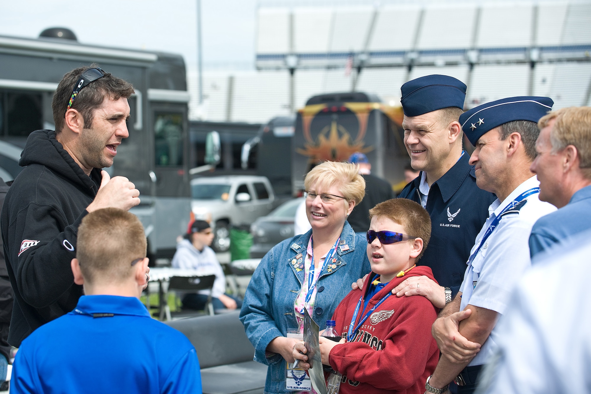 (Left) Elliott Sadler, driver for Air Force sponsored car number 19, speaks with Maj. Gen. David M. Edgington, Chief of Staff, U.S. Joint Forces Command, Norfolk, Va., and Chief Master Sgt. of the Air Force James A. Roy and their guests before the NASCAR Nationwide Series race May 16. (U.S. Air Force photo/Roland Balik)