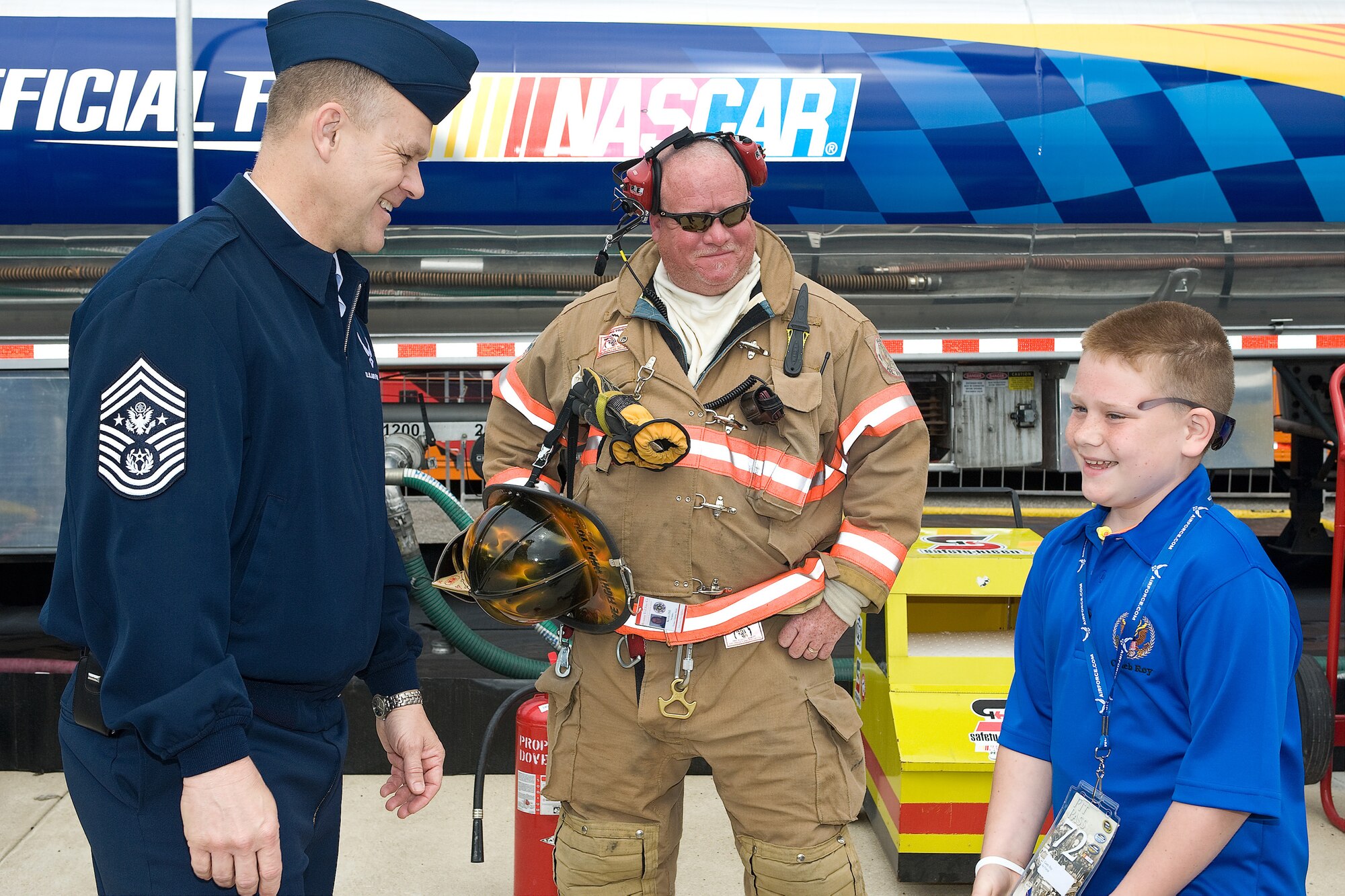 (Left) Chief Master Sgt. of the Air Force James A. Roy and his son Caleb, go behind the scenes and into the racing pit before the NASCAR Nationwide Series race May 16. Chief Roy and his guests got to see what a pit crew works with during a race. (U.S. Air Force photo/Roland Balik)