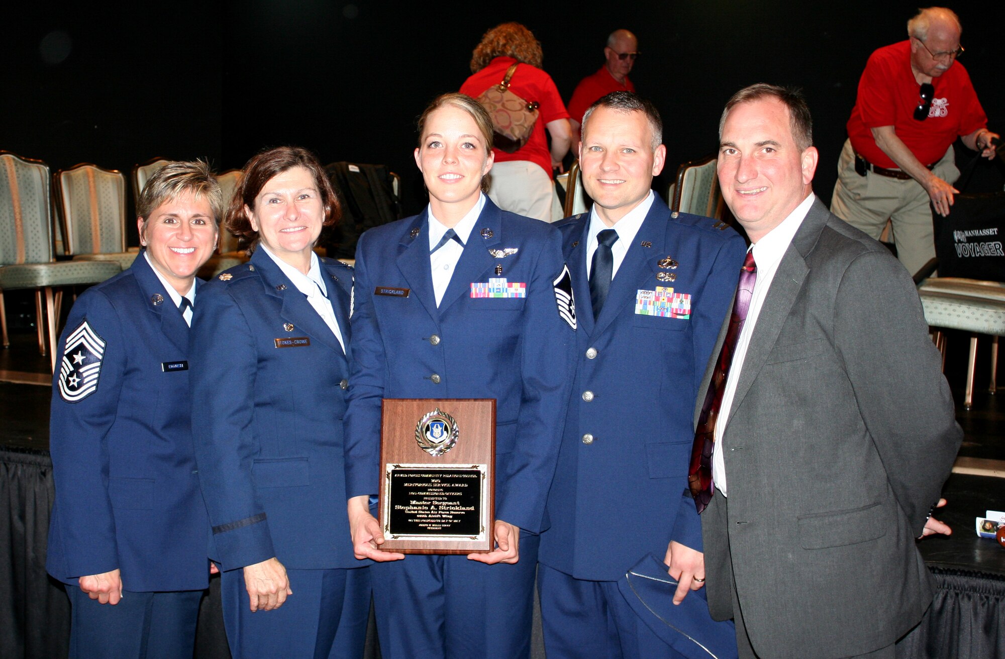 WRIGHT-PATTERSON AIR FORCE BASE, Ohio – Master Sgt. Stephanie Strickland (center), 445th Aeromedical Evacuation Squadron,  was supported by (left to right) Chief Peri Rogowski, 445th Airlift Wing command chief; Lt. Col. Linda Stokes-Crowe, 445th AES commander; Capt. William Smart, Commander, AFMC HQ Operations Support; and Mr. Brad Borowy, Deputy Chief, AFMC HQ Operations Support, during the 2010 Central Ohio Armed Forces Day Observance Luncheon sponsored by the Military/Veterans Educational Foundation and the USO of Central Ohio where she was recognized as one of the top 10 nominees for the 2010 Service Persons of the Year Distinguished Service Award sponsored by the Armed Forces Community Relations Council of Columbus, Ohio. (U.S. Air Force photo/Capt. Caroline Wellman)