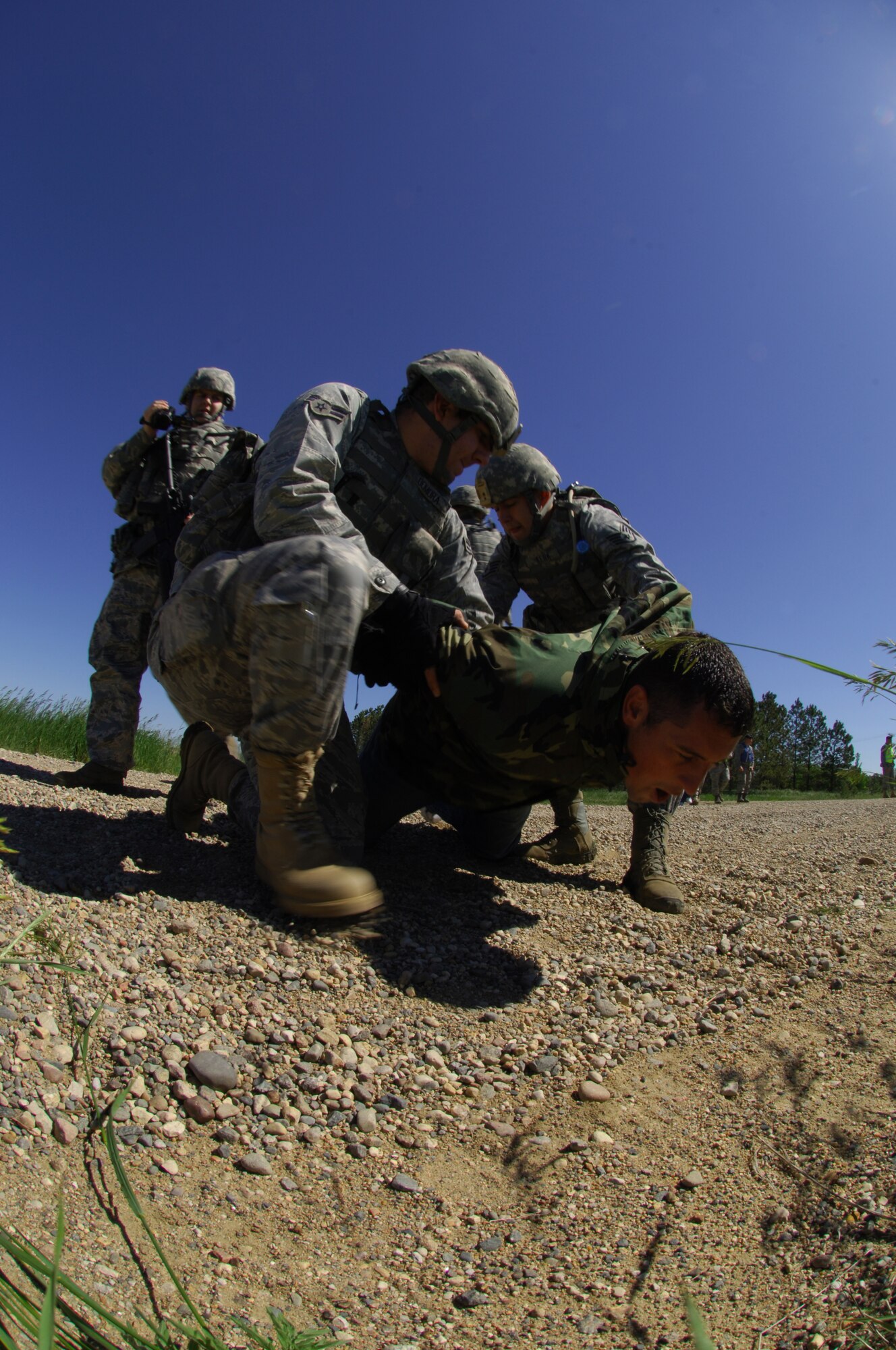 MINOT AIR FORCE BASE, N.D—Members from the 91st Missile Security Forces Squadron, take down a “protestor” in the missile complex  during a Nuclear Surety Inspection exercise here June 23. The 5th Bomb Wing and 91st Missile Wing work together to keep the installation and missile complex safe and secure. The teamwork and coordination between base agencies during exercises like these are why the Minot AFB antiterrorism program won the Air Force Global Strike Command’s Best Installation Antiterrorism Program of the Year for 2009. (U.S.  Air Force photo by Tech. Sgt. Lee A. Osberry Jr.)