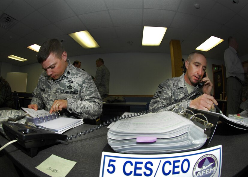 MINOT AIR FORCE BASE, N.D. – Lt. Col. Monte Harner, 5th Civil Engineer Squadron commander, and Senior Master Sgt. Brian Nolan, 5th CES superintendant, go over checklists during a joint antiterrorism exercise here June 3.  The exercise involved several agencies, including the base, Bismarck Army National Guard, Minot Fire and Rescue Service, and the Minot Police Department. The teamwork and coordination between base agencies during exercises like these are why the Minot AFB antiterrorism program won the Air Force Global Strike Command’s Best Installation Antiterrorism Program of the Year for 2009. (U.S. Air Force photo by Staff Sgt. Miguel Lara III)