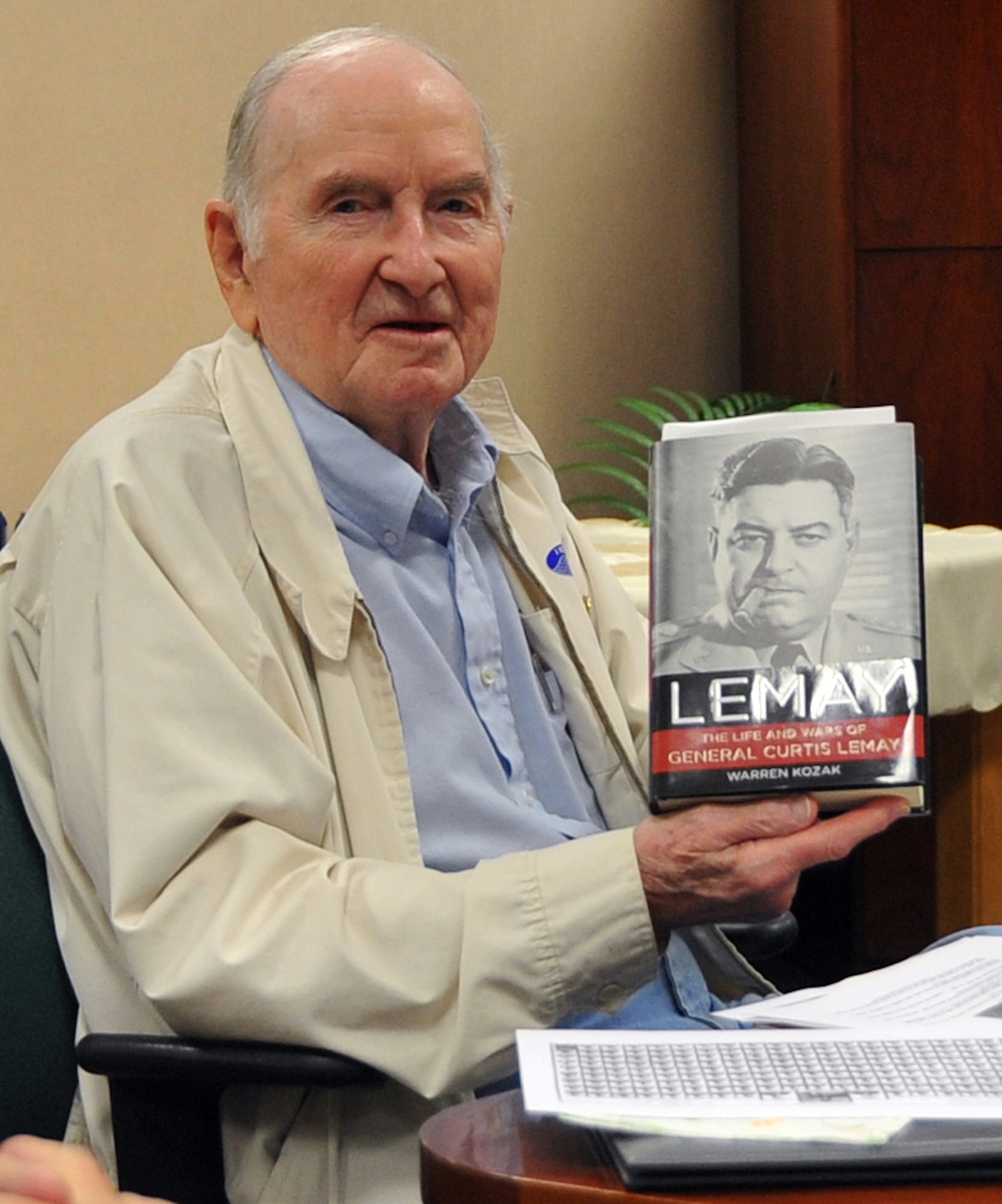 OFFUTT AIR FORCE BASE, Neb. -- John Watters poses with the book "LeMay: The life and wars of General Curtis LeMay" by Warren Kozak at the Thomas S. Power Library here May 18 during a meeting of Offutt's Professional Reading Society. Mr. Watters served on General LeMay's staff and worked on B-17's during his career in the Air Force. Among his many accomplishments, General LeMay served as the commander of Strategic Air Command here from October 1948 to June 1957 and later served as Air Force chief of staff. The LeMay Aero Club is named in his honor. U.S. Air Force Photo by Jeff W. Gates.