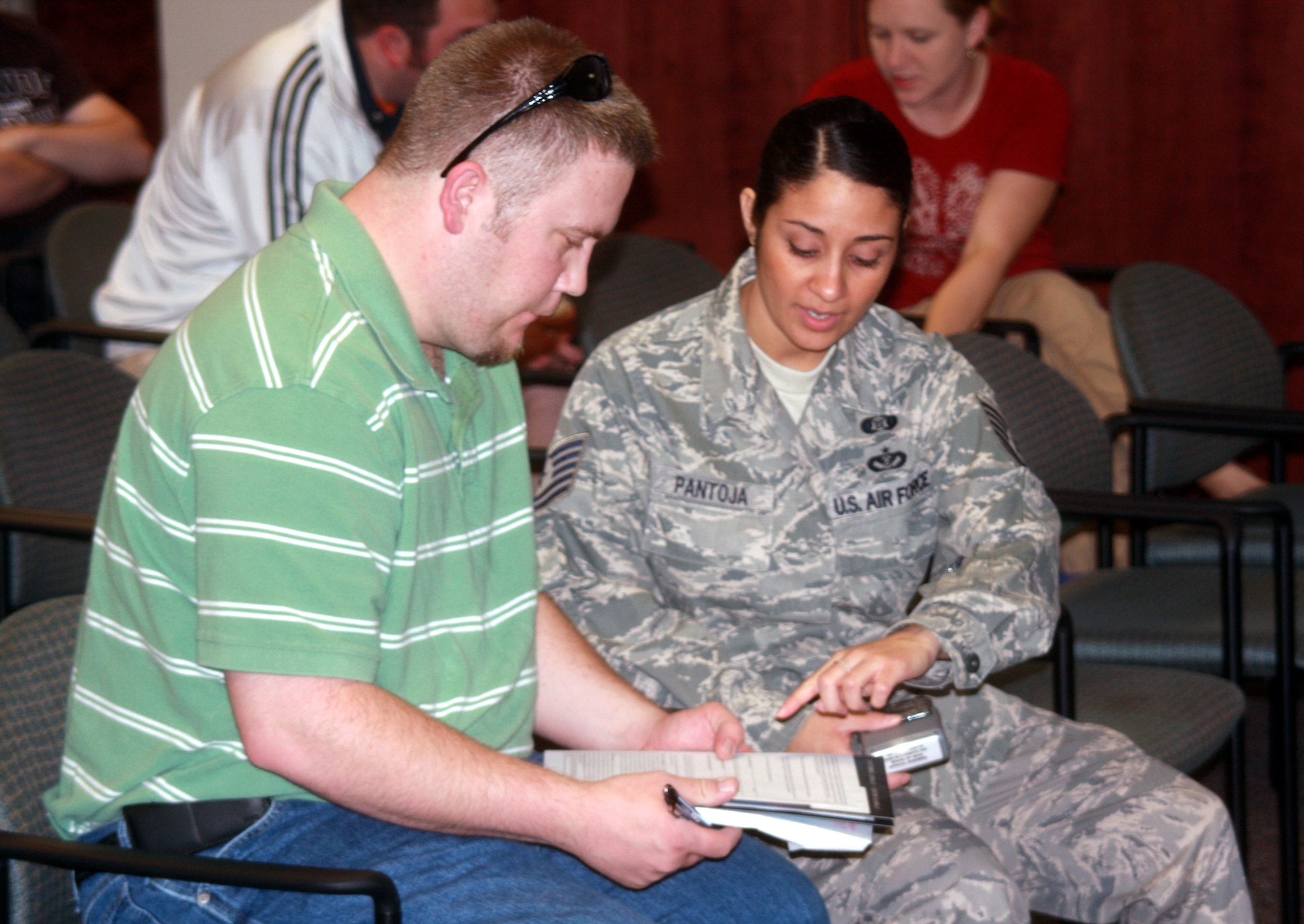 WRIGHT-PATTERSON AIR FORCE BASE, Ohio – Tech. Sgt. Linda Pantoja, 445th Mission Support Flight, helps Cristopher Delaet fill out his paperwork during the 445th Airlift Wing Individual Ready Reserve Muster May 15.  The 445th Airlift Wing hosted more than 175 members of the IRR attending the event.  An IRR Muster is a recruiting tool to get Inactive Ready Reserve’s people to rejoin and/or educate them about their benefits.  (U.S. Air Force photo/ Senior Airman Mikhail Berlin)