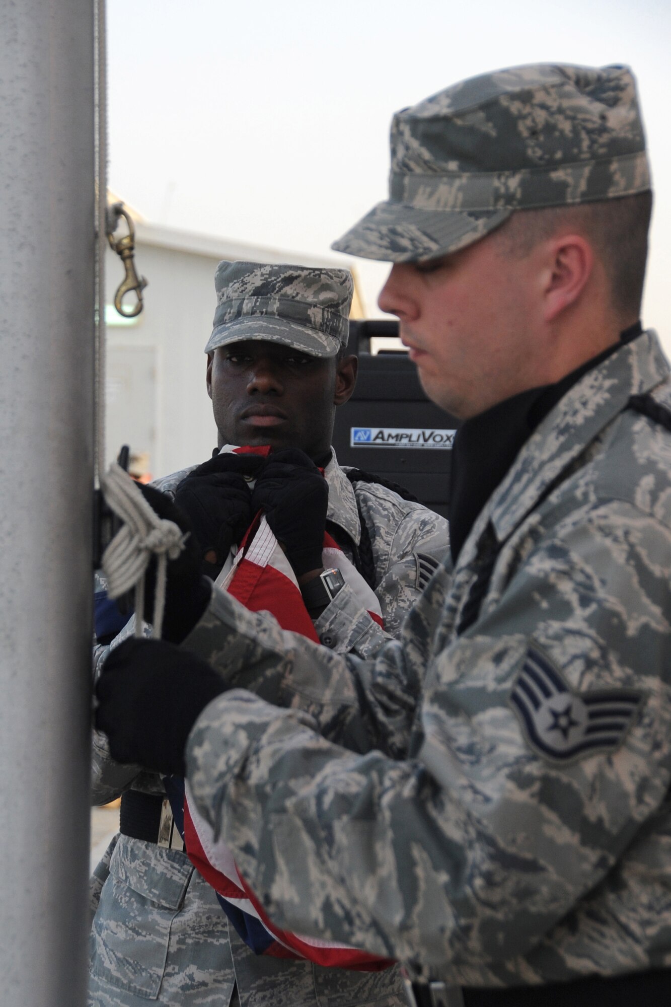 Members of the 380th Air Expeditionary Wing Honor Guard along with members from across the 380th AEW perform retreat, a ceremony that marks the end of the duty day, at an undisclosed location in Southwest Asia on May 14, 2010.  Airmen from across the wing join every week to pay their respects. The 380th AEW supports Operations Iraqi Freedom and Enduring Freedom and the Combined Joint Task Force-Horn of Africa. Its comprised of four groups and 12 squadrons and the wing's deployed mission includes air refueling, surveillance and reconnaissance in support of overseas contingency operations in Southwest Asia.(U.S. Air Force photo/Senior Airman Jenifer H. Calhoun/Released)