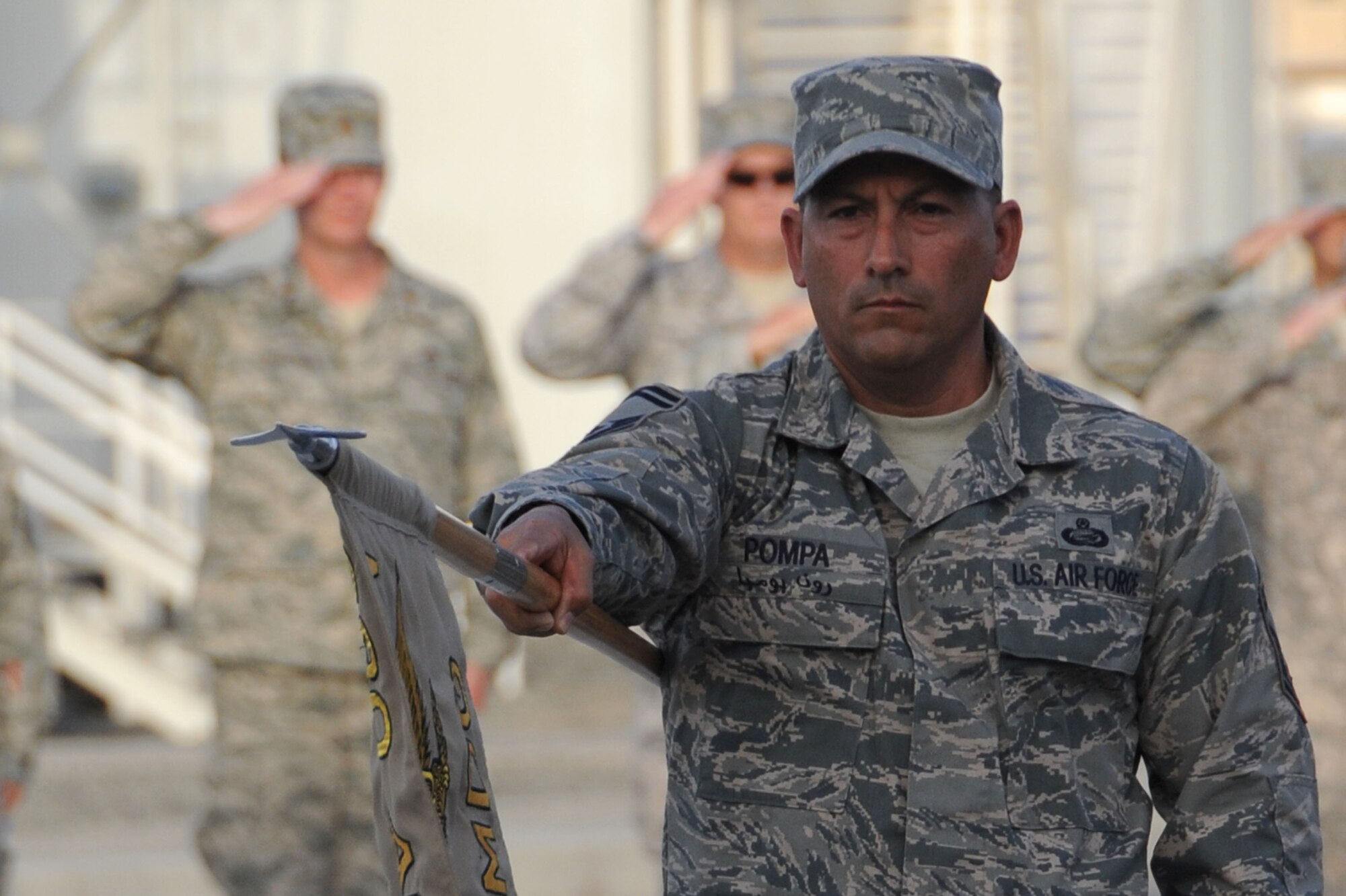 Senior Master Sgt. Ronald Pompa, 380th Air Expeditionary Wing host nation coordinator,  along with members from across the 380th AEW perform retreat at an undisclosed location in Southwest Asia on May 14, 2010.  Airmen from across the wing join every week to pay respect during retreat. The 380th AEW supports Operations Iraqi Freedom and Enduring Freedom and the Combined Joint Task Force-Horn of Africa. The 380th AEW is comprised of four groups and 12 squadrons and the wing's deployed mission includes air refueling, surveillance and reconnaissance in support of overseas contingency operations in Southwest Asia.(U.S. Air Force photo/Senior Airman Jenifer H. Calhoun/Released)