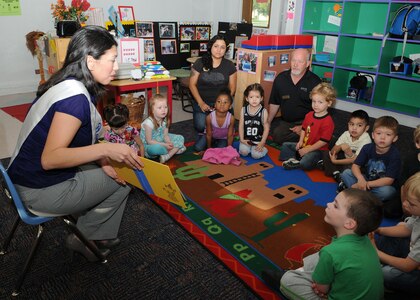 Randolph Air Force Base ambassador Jaclyn Rodriguez, reads to children at the Randolph Youth Center March 30. Ms. Rodriguez is a civilian contract specialist for the Air Education and Training Command, headquartered here. As an Ambassador, Ms. Rodriguez represents Randolph at various events including the annual San Antonio Fiesta event. (U.S. Air Force photo by David Terry)