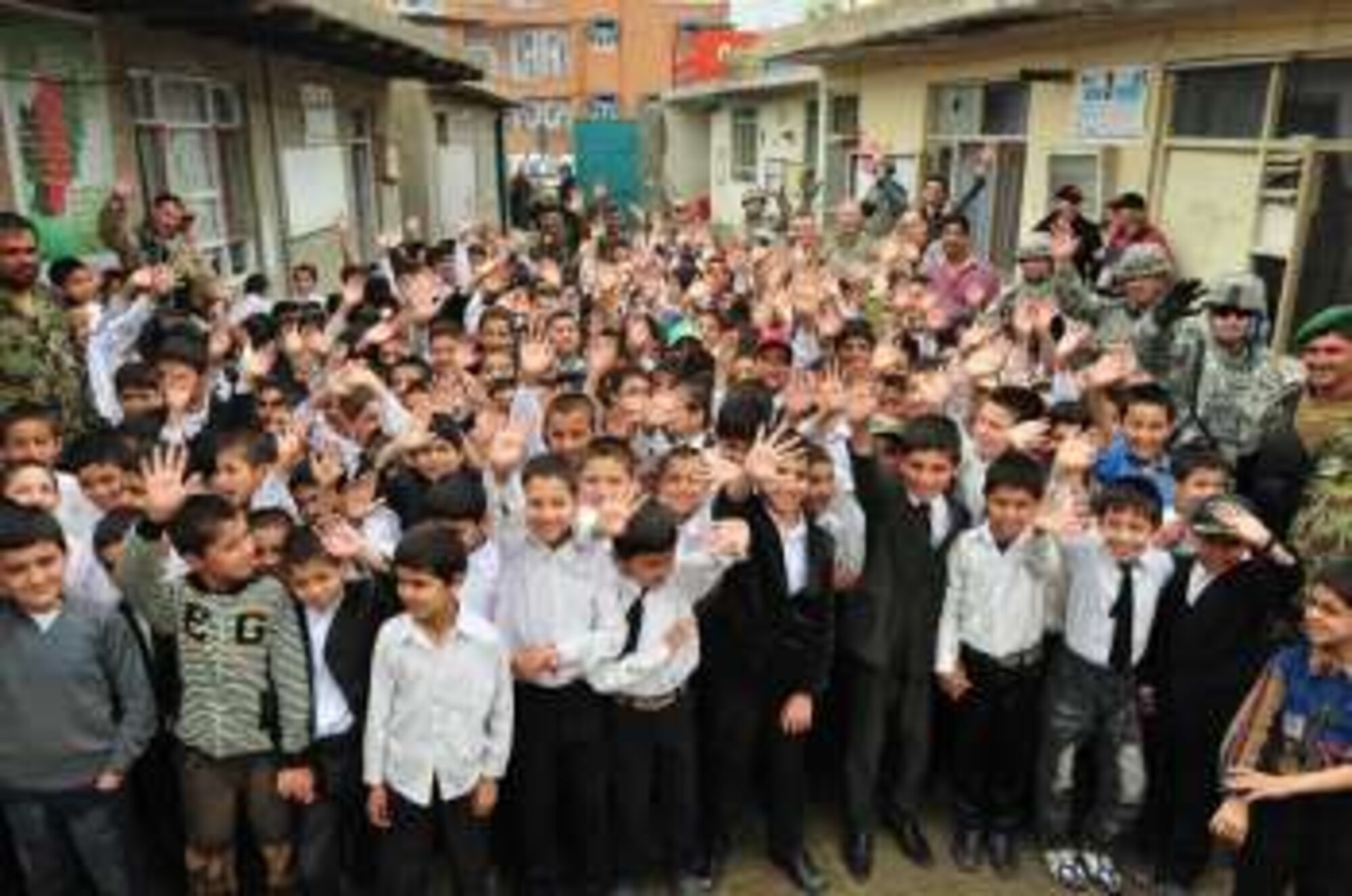 Afghan soldiers and U.S. Airmen from the 438th Air Expeditionary Wing distributed school supplies May 17, 2010, to 1300 students of the Hope School in Kabul, Afghanistan. (U.S. Navy photo/MC1 Elizabeth Burke/Released)