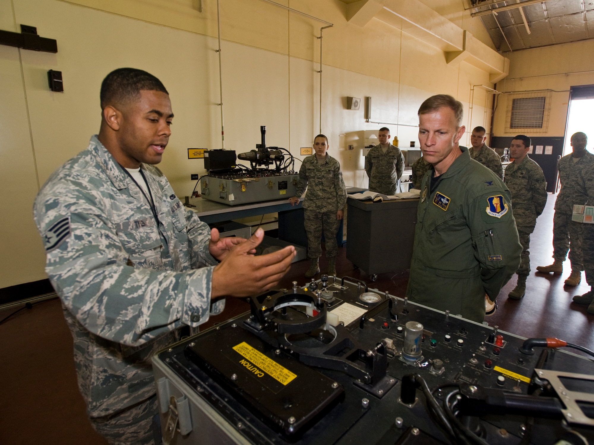 MISAWA AIR BASE, Japan -- Staff Sgt. Jonathan Tyler, 35th Maintenance Squadron Precision guidance munitions crew chief, explains characteristics of an AIM-9M test set to Col. RC Craig, 35th Fighter Wing vice commander, May 18 at the 35th MXS missile shop. The AIM-9M test set is a portable unit used to test the guidance control section of the AIM-9 sidewinder missile. (U.S. Air Force photo/Senior Airman Jamal D. Sutter)