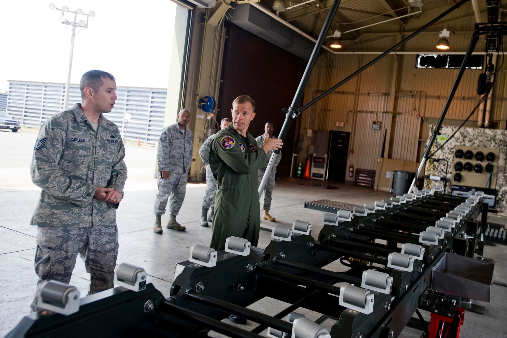 MISAWA AIR BASE, Japan -- Tech. Sgt. Thomas Carlisle, 35th Maintenance Squadron conventional munitions technician, shows the Munitions Assembly Conveyor II to Col. RC Craig, 35th Fighter Wing vice commander, May 18. The 35th MXS has had the MAC II for two weeks. It is used to inspect and transport munitions. (U.S. Air Force photo/Senior Airman Jamal D. Sutter)