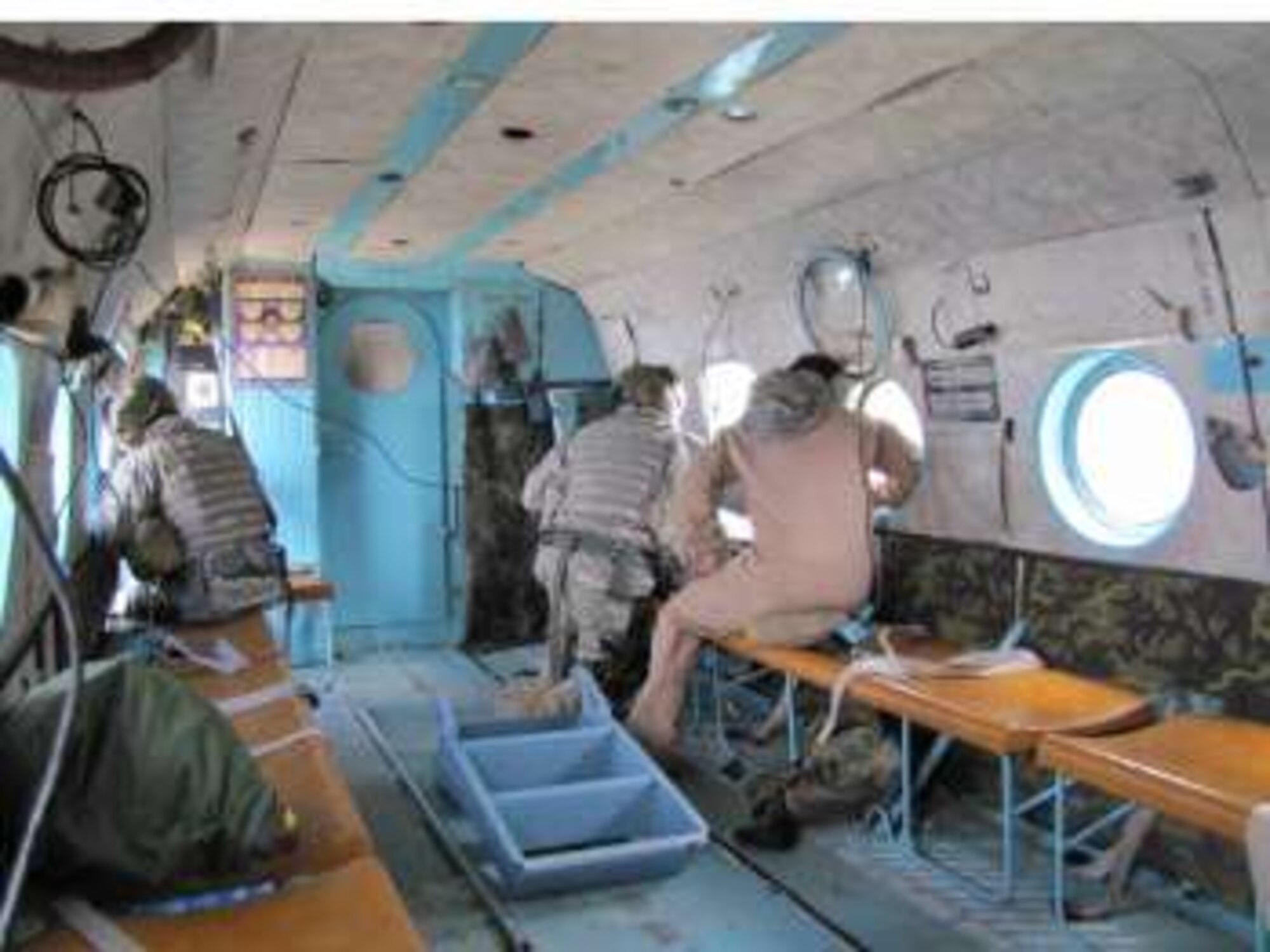 Members of the Afghan National Army Air Corps and Combined Airpower Transition Force search for a missing AN-24 passenger jet while riding in a Mi-17 transport helicopter in the Hindu Kush mountains north of Kabul on May 18th, 2010.  (U.S. Air Force photo by Capt. Rob Leese/RELEASED)