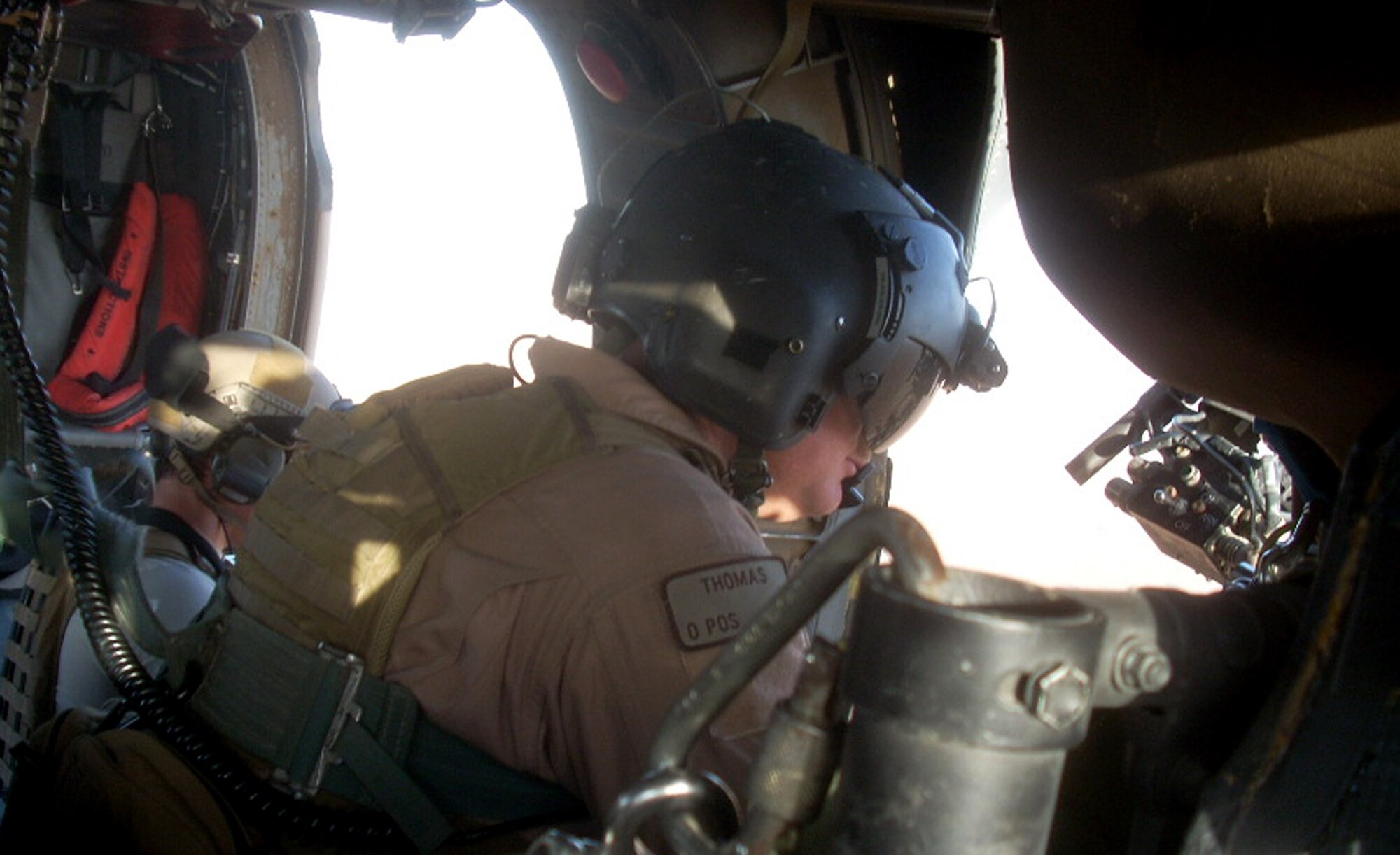 Master Sgt. Dustin Thomas, HH-60G aerial gunner, scans the terrain for threats in Afghanistan July 17, 2009. Sergeant Thomas, along with Capt. Robert Rosebrough, 1st Lt. Lucas Will, and Staff Sgt. Tim Philpott, members of the 33rd Rescue Squadron at Kadena Air Base, Japan, were recently announced as the winners of the MacKay Trophy and the Jolly Green Association Award for a mission to rescue Army Soldiers and fellow Airmen July 29, 2009 during their deployment to Kandahar Air Base, Afghanistan. At the time of the mission they were attached to the 129th ERQS. (Courtesy Photo)