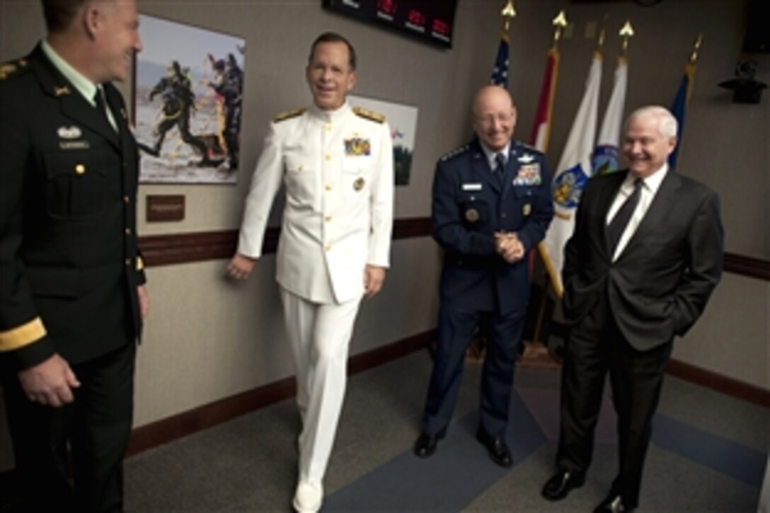 Canadian Gen. Walter Natynczyk, chief of the defense staff, left, U.S. Navy Adm. Mike Mullen, chairman of the Joint Chiefs of Staff, U.S. Air Force Gen. Gene Renuart and U.S. Defense Secretary Robert M. Gates share a laugh prior to the U.S. Northern Command/ North American Aerospace Defense Command Change of Command ceremony on Peterson Air Force Base, Colo., May 19, 2010. 