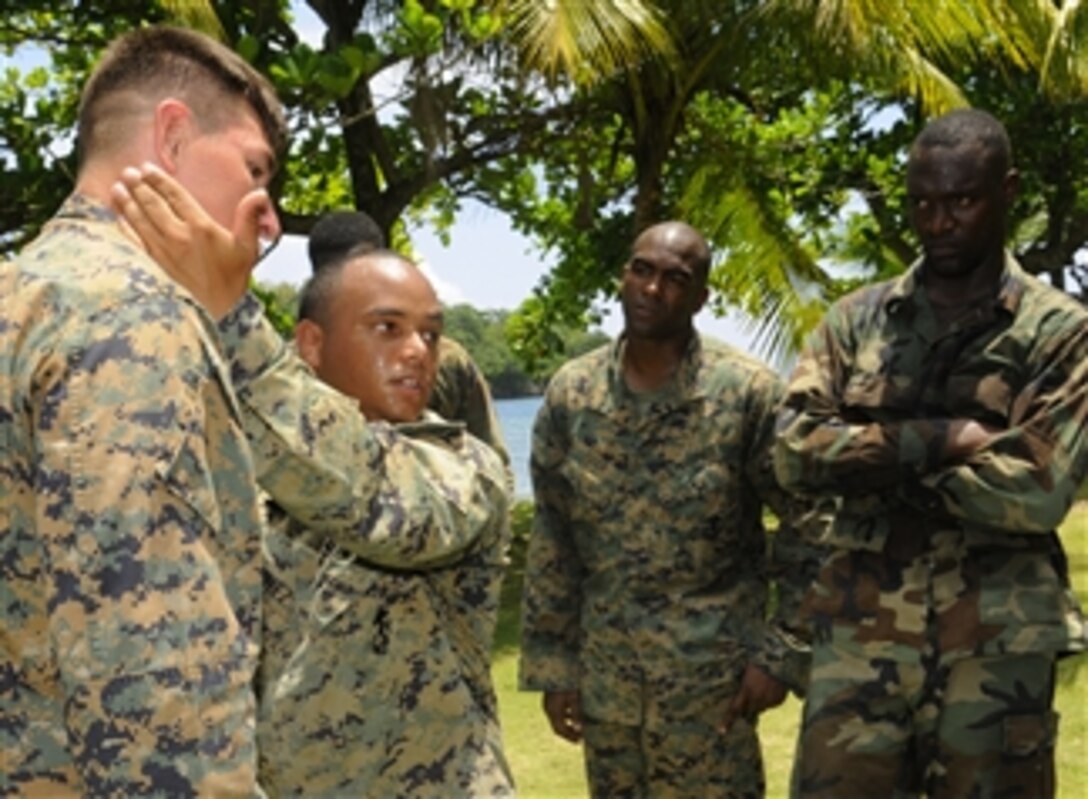 U.S. Marine Corps Sgts. Edan Valkner (left) and Juan Martinez demonstrate a ground fighting technique for Marines embarked aboard High Speed Vessel Swift (HSV 2) and members of the Jamaican Defense Force in Port Antonio, Jamaica, on May 17, 2010.  The ship is deployed in support of Southern Partnership Station 2010.  