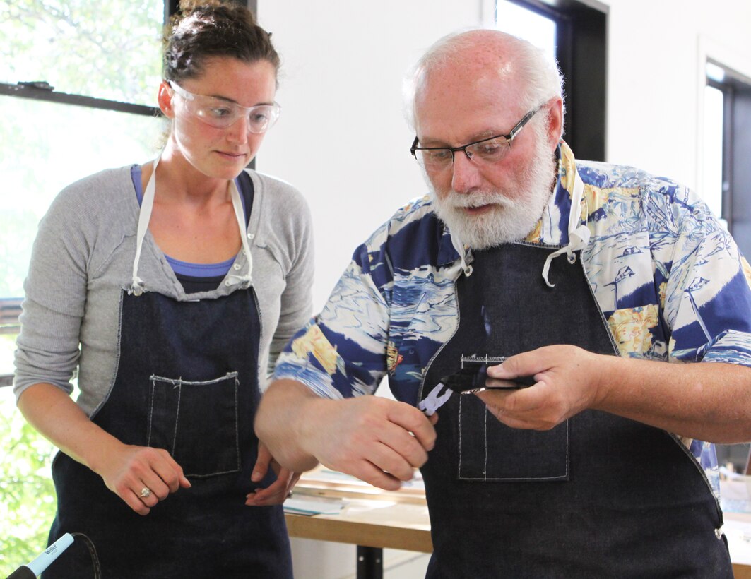 Buddy Smith (right), stained glass instructor, Camp Pendleton’s Arts and Crafts Hobby Shop, shows student, Rachel Kennedy, the correct way to cut during a Stained Glass Course at the base’s Hobby Shop. The Hobby Shop is a unique and inexpensive place for patrons to explore their creativity that offers classes for woodworking, cake decorating, sewing, pottery, guitar and many other activities.