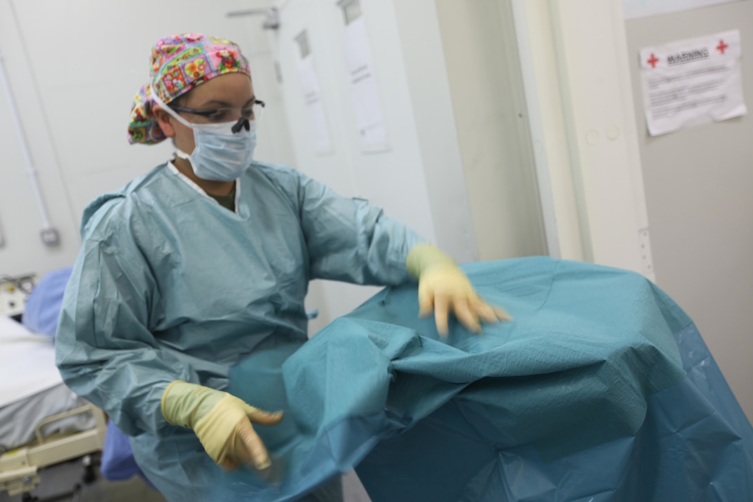 Petty Officer 2nd Class Beatriz M. Salinas, surgical technician with Surgical Company B, 1st Medical Battalion, 1st Marine Logistics Group (Forward), prepares a work station for an operation at the United Kingdom Bastion Hospital, Camp Bastion, Afghanistan, May 19. Salinas, 24, from Hialeah, Fla., is one of three corpsmen of 1st MLG (FWD) partnered with the joint hospital staff to treat trauma patients wounded in combat. The United States and the U.K.’s partnership plays an important role in the success if this hospital.