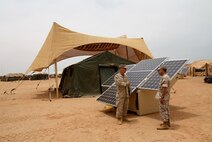 TAN TAN, Morocco -- Maj. Sean M. Sadlier (left) of the U.S. Marine Corps Expeditionary Energy Office explains the solar power element of the Expeditionary Forward Operating Base concept to Col. Anthony Fernandez, African Lion 2010 task force commander, during the testing phase of this sustainable energy initiative here May 19.  The ExFOB is designed primarily for use by small Marine Corps units at forward operating bases in Afghanistan.