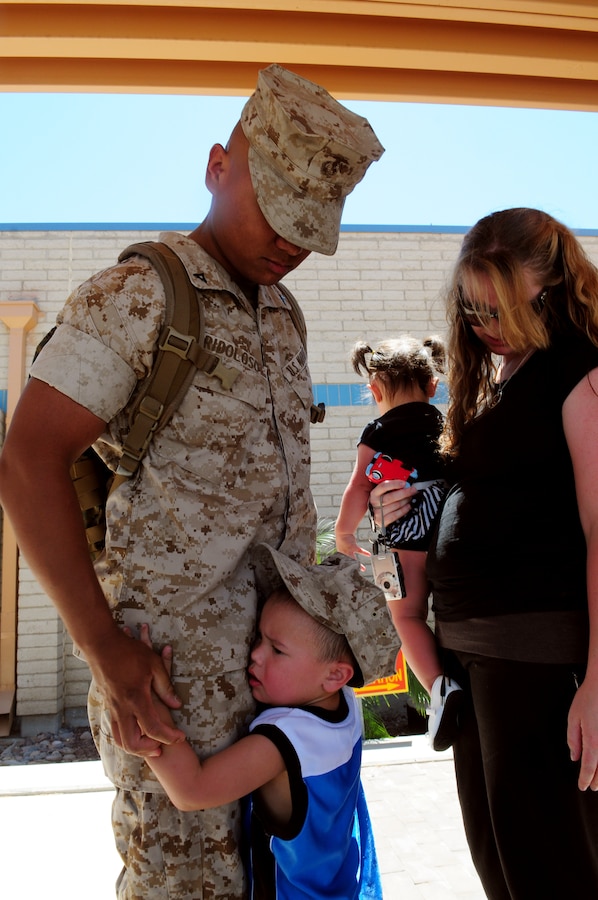 Ryan Ridoloso, 3, hugs his father Lance Cpl. Mark Ridoloso, Marine Attack Squadron 311 powerline mechanic, goodbye before boarding a KC-130 Hercules at the Marine Corps Air Station in Yuma, Ariz., May 19, 2010. Approximately 110 members of VMA-311 and Marine Aviation Logistics Squadron 13 left Yuma May 19 for the USS Peleliu in San Diego, with six AV-8B Harriers following them Sunday. The Marines and sailors will deploy aboard the Peleliu with the 15th Marine Expeditionary Unit, which will patrol the waters of the Pacific and Indian Oceans for pirates. “I feel nervous, but excited,” said Ridoloso, who has never deployed. “The ship is uncomfortable and miserable, but I’m excited to actually go out and do something. I am sad, though, that I won’t be here to witness my daughter’s birth. I was here for my first two kids being born and I hate that I have to miss the third.”