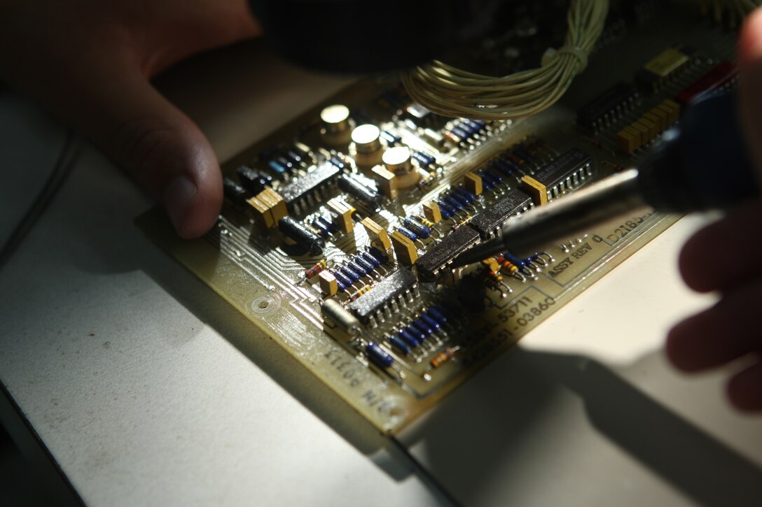 A Marine with Wire Platoon, Electronics Maintenance Company, 2nd Maintenance Battalion, Combat Logistics Regiment 25, 2nd Marine Logistics Group solders an electrical part onto a circuit card, May 20. By repairing these circuit cards as opposed to purchasing new ones, with every repaired card a total of anywhere from one to 20 thousand dollars of the Marine Corps’ spending funds are saved.