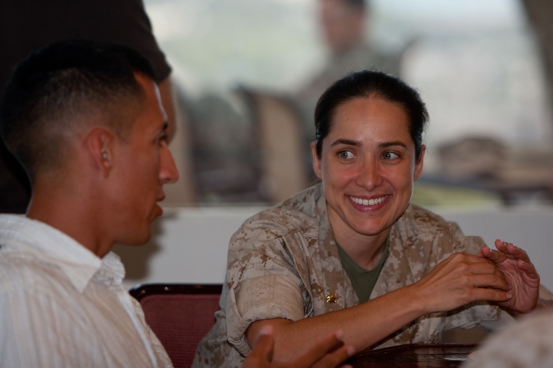 Major Kris M. Pirttinen (right), facilities officer for Headquarters and Service Battalion, U.S. Marine Corps Forces, Pacific, and Capt. Marcos Azua, MarForPac comptroller, discuss their day May 20 at the Sunset Lanai, Camp H. M. Smith, Hawaii, during MarForPac's Right Hand Man Night. Battalion officials organized the event to thank the Marines around the battalion whom their supervisors recognized as the "go-to guy" in their section.