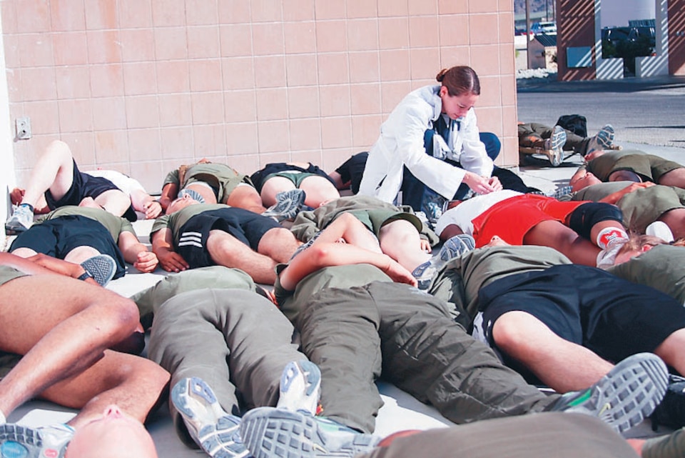 Navy Lt. Juliana Palumba, the acting triage officer, reads the dog tags of a simulated casualty during a mass fatality scenario at the Robert E. Bush Naval Hospital May 20 in conjunction with Exercise Golden Guardian, the California-wide exercise. The Combat Center responded to a mock 7.8 magnitude earthquake May 18-20, to assess the communication and response capabilities of the emergency operations center.