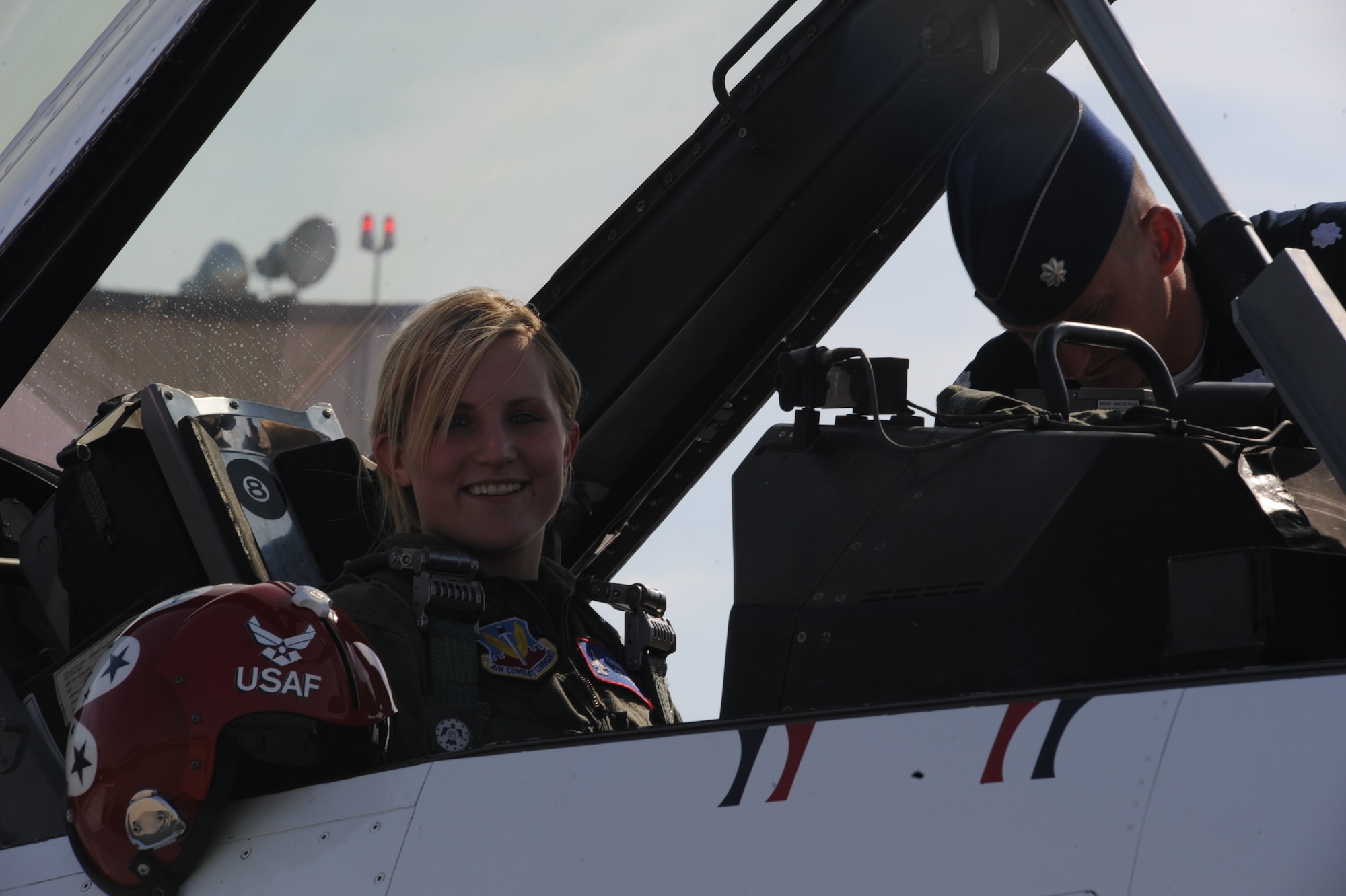 2010 Winter Olympics Silver Medalist winner, Monique Lamoureux, smiles as Lt Col. Derek Routt, U.S. Air Force Thunderbirds, preps her for the flight May 20 at Grand Forks Air Force Base, N.D. Ms. Lamoureux  was picked as one of the participants in the Thunder Over the Red River Air Show Hometown Hero flight. Hometown Heroes is a program that recognizes ordinary people as heroes throughout the community. (U.S. Air Force photo by Airman 1st Class Amber Price)