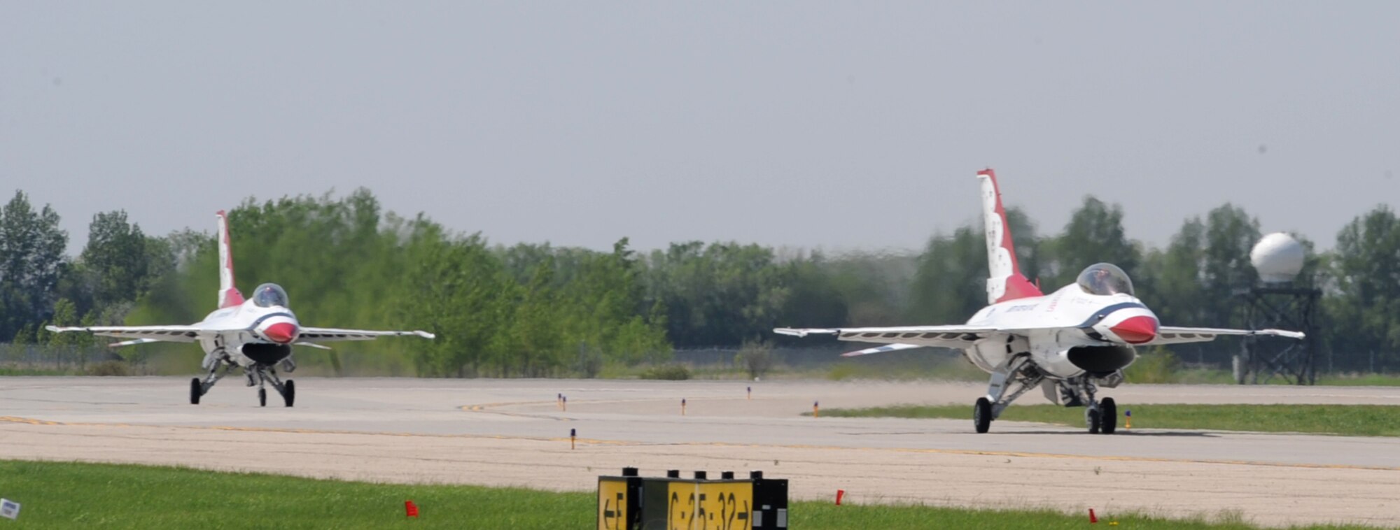 Two F-16 Fighting Falcons, part of the United States Air Force Thunderbird Aerial Demonstration Team, taxi-in on the runway at Grand Forks Air Force Base, N.D. May 20. The Thunderbirds will highlight the base’s Thunder over the Red River Air Show May 22. (U.S. Air Force photo by Airman 1st Class Amber Price)
