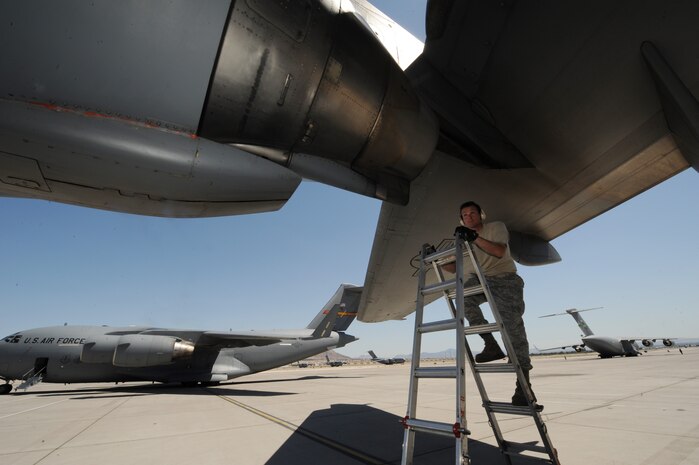 NELLIS AIR FORCE BASE, Nev. -- Tech. Sgt. Patrick Remfrey performs a post flight maintenance check on a C-17 Globemaster III at Nellis Air Force Base following a Mobility Air Forces Exercise, May 19. Approximately 40 C-17 Globemaster III and C-130 Hercules aircraft from Air Force bases in Alaska and the Continental United States met over the Nevada Test and Training Range to conduct air and ground operations as part of the bi-annual exercise which is planned and executed by students assigned to the U.S. Air Force Weapons School. Sergeant Remfrey is crew chief assigned to the 62nd Aircraft Maintenance Squadron, McChord AFB, Wash. (U.S. Air Force photo by Master Sgt. Kevin J. Gruenwald)




