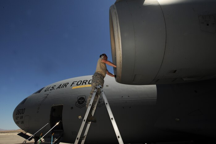 NELLIS AIR FORCE BASE, Nev. -- Tech. Sgt. Patrick Remfrey checks the intake on a C-17 Globemaster III at Nellis Air Force Base following a Mobility Air Forces Exercise, May 19. Approximately 40 C-17 Globemaster III and C-130 Hercules aircraft from Air Force bases in Alaska and the Continental United States met over the Nevada Test and Training Range to conduct air and ground operations as part of the bi-annual exercise which is planned and executed by students assigned to the U.S. Air Force Weapons School. Sergeant Remfrey is crew chief assigned to the 62nd Aircraft Maintenance Squadron, McChord AFB, Wash. (U.S. Air Force photo by Master Sgt. Kevin J. Gruenwald)




