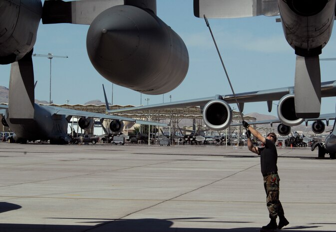 NELLIS AIR FORCE BASE, Nev. -- Tech. Sgt. Brian Wiltjer aligns the props on a C-130 Hercules at Nellis Air Force Base following a Mobility Air Forces Exercise, May 19. Approximately 40 C-17 Globemaster III and C-130 Hercules aircraft from Air Force bases in Alaska and the Continental United States met over the Nevada Test and Training Range to conduct air and ground operations as part of the bi-annual exercise which is planned and executed by students assigned to the U.S. Air Force Weapons School. Sergeant Wiltjer is a crew chief assigned to the 153rd Airlift Wing, Wyoming Air National Guard. (U.S. Air Force photo by Master Sgt. Kevin J. Gruenwald)


