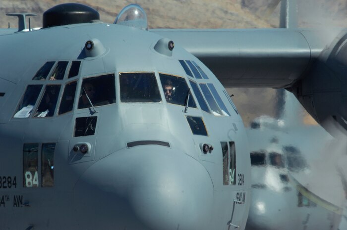 NELLIS AIR FORCE BASE, Nev. -- Two C-130 Hercules taxi at Nellis Air Force Base following a Mobility Air Forces Exercise May 19. Approximately 40 C-17 Globemaster III and C-130 Hercules aircraft from Air Force bases in Alaska and the Continental United States met over the Nevada Test and Training Range to conduct air and ground operations as part of the bi-annual exercise which is planned and executed by students assigned to the U.S. Air Force Weapons School. (U.S. Air Force Photo by Master Sgt. Kevin J. Gruenwald)

