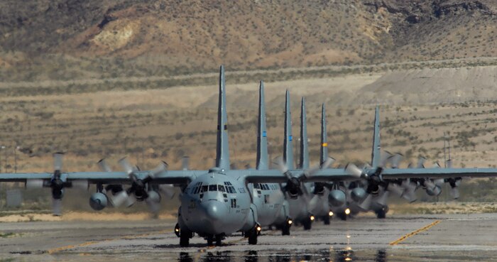 NELLIS AIR FORCE BASE, Nev. -- A line of C-130 Hercules taxi at Nellis Air Force Base following a Mobility Air Forces Exercise, May 19. Approximately 40 C-17 Globemaster III and C-130 Hercules aircraft from Air Force bases in Alaska and the Continental United States met over the Nevada Test and Training Range to conduct air and ground operations as part of the bi-annual exercise which is planned and executed by students assigned to the U.S. Air Force Weapons School. (U.S. Air Force photo by Master Sgt. Kevin J. Gruenwald)

