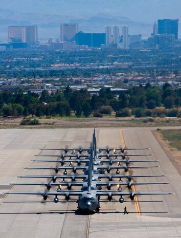 NELLIS AIR FORCE BASE, Nev. -- A row of C-130 Hercules taxi at Nellis Air Force Base following a Mobility Air Forces Exercise, May 19. Approximately 40 C-17 Globemaster III and C-130 Hercules aircraft from Air Force bases in Alaska and the Continental United States met over the Nevada Test and Training Range to conduct air and ground operations as part of the bi-annual exercise which is planned and executed by students assigned to the U.S. Air Force Weapons School. (U.S. Air Force Photo by Airman 1st Class Brett Clashman)