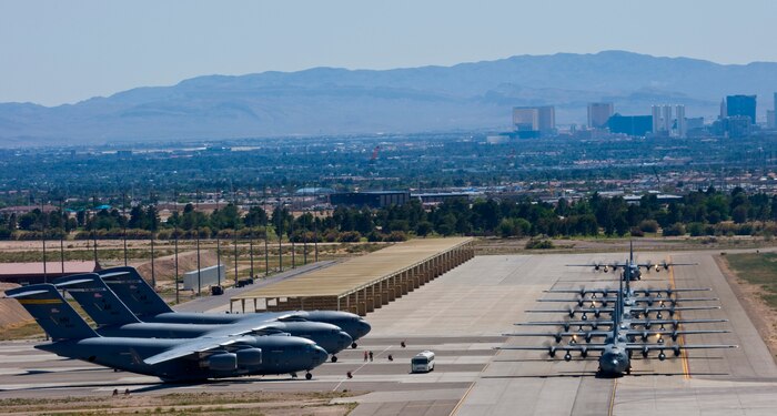 NELLIS AIR FORCE BASE, Nev. -- A line of C-130 Hercules taxi at Nellis Air Force Base following a Mobility Air Forces Exercise, May 19. Approximately 40 C-17 Globemaster III and C-130 Hercules aircraft from Air Force bases in Alaska and the Continental United States met over the Nevada Test and Training Range to conduct air and ground operations as part of the bi-annual exercise which is planned and executed by students assigned to the U.S. Air Force Weapons School. (U.S. Air Force Photo by Airman 1st Class Brett Clashman)