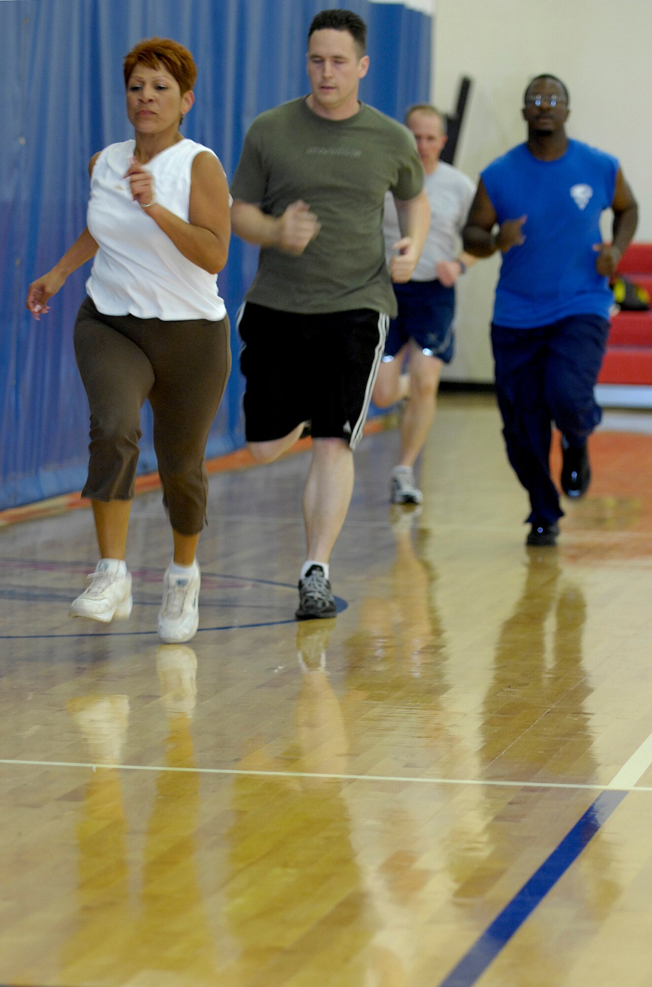 VANDENBERG AIR FORCE BASE, Calif. - Leading the group of attendees at the Hardcore 30-Minute Workout class Denise King, from the 30th Contracting Squadron, sprints around the court here Tuesday, May 18, 2010. The workout program is provided at the base fitness center at lunchtime from noon to 12:30 p.m. (U.S. Air Force photo/Senior Airman Andrew Lee)